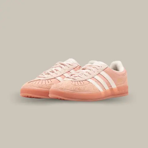Paire de Adidas Gazelle Indoor Bad Bunny Cabo Rojo vue en perspective, sneaker rose clair avec détails en daim, bandes blanches et semelle gum translucide, disponible sur Offsneakz.