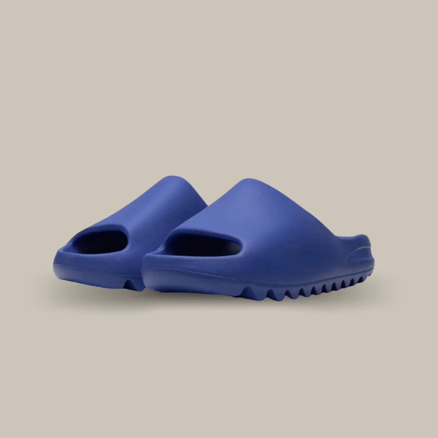 La Yeezy Slide Azure présente une structure en mousse EVA à la teinte bleu roi. Son aspect monobloc dévoile une outsole dentelée pour un amorti optimal.