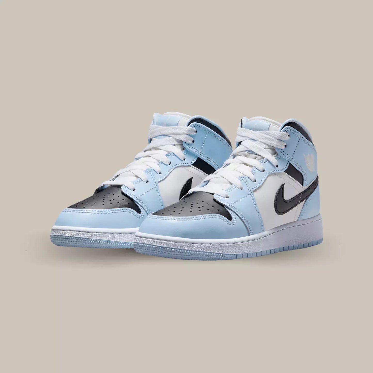 La Air Jordan 1 Mid Ice Blue se présente à travers une tige en cuir blanc cassé qui s’accorde au logo Wings présent sur le rabat. On remarque ensuite des superpositions également en cuir dans un coloris bleu ciel.