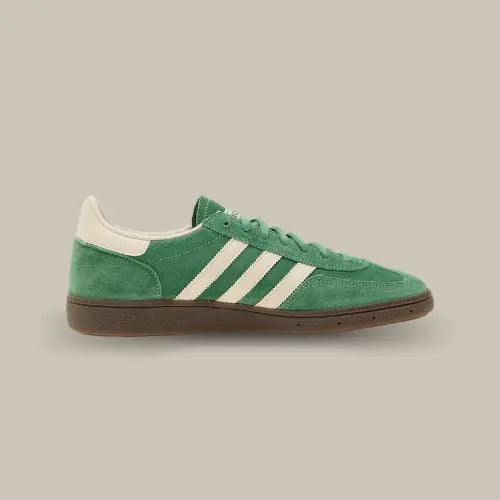 La Adidas Handball Spezial Preloved Green White de côté avec son coloris vert, ses trois bandes blanches accordées au heel tab et sa semelle en gomme de caoutchouc.