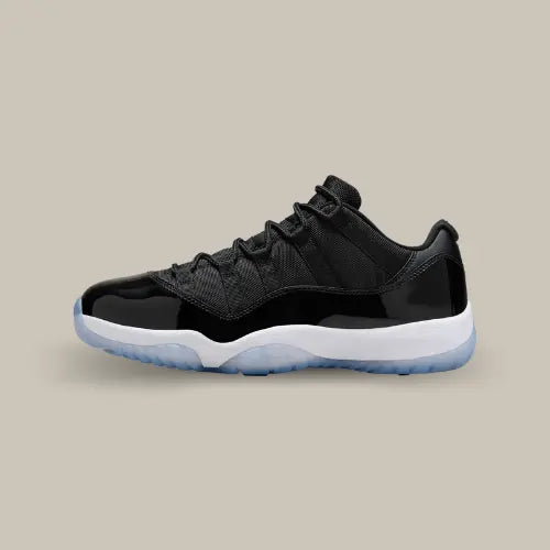 La Air Jordan 11 Retro Low Space Jam avec sa base en mesh noir, son mudguard en cuir verni noir, sa midsole blanche et son outsole icy bleu clair.
