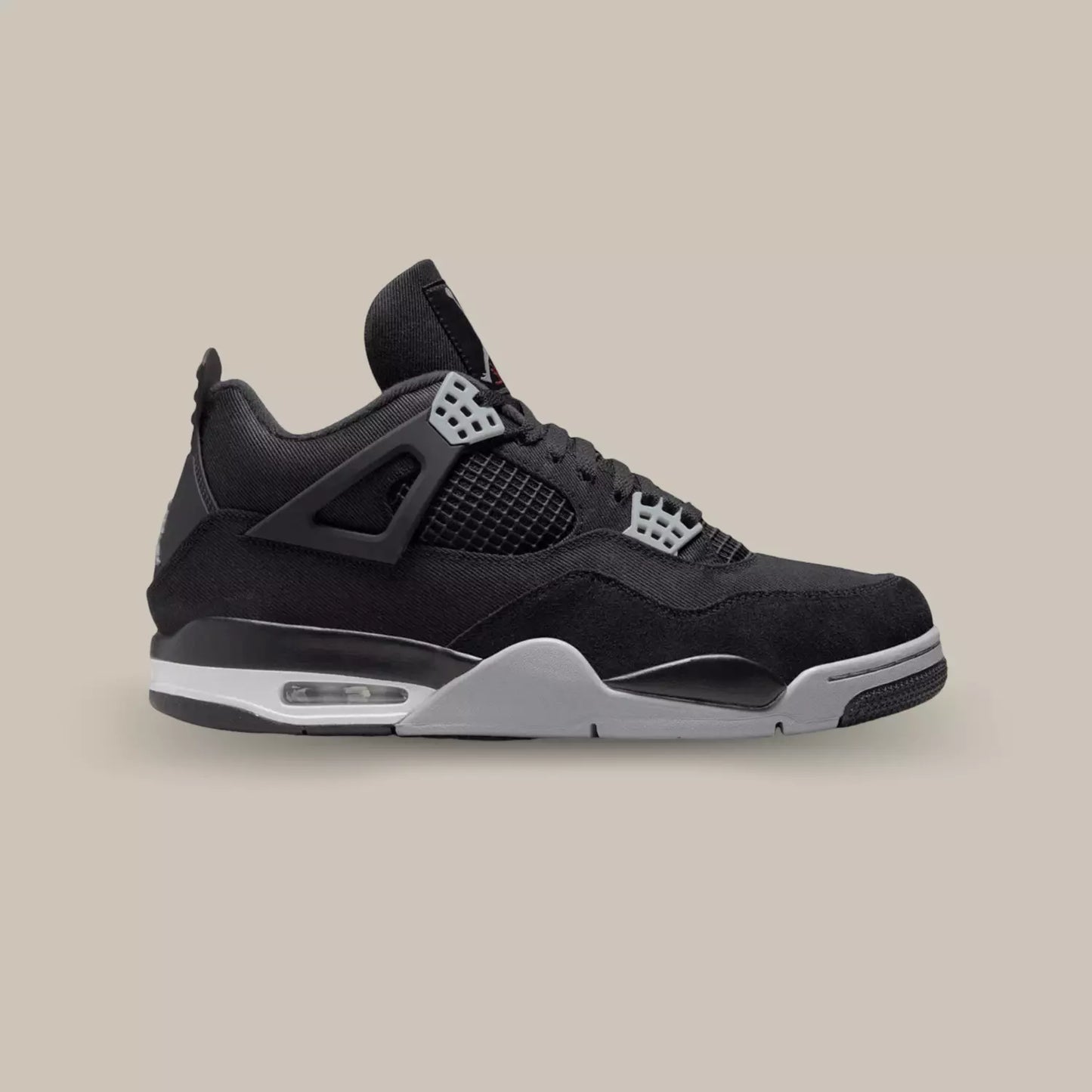 La Air Jordan 4 Black canvas vue de coté avec sa base en toile noir, sa cage en TPU et ses œillets gris.