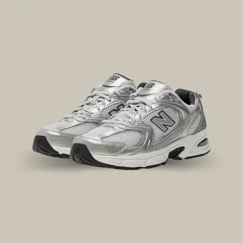 La New Balance 530 Grey Matter Silver Metallic revisite le style rétro-running avec une touche futuriste et un confort exceptionnel. Son design mêle mesh respirant et empiècements en cuir métallisé, offrant une allure audacieuse et moderne. Conçue pour le confort, elle intègre la technologie ABZORB, garantissant un amorti optimal et une absorption des chocs idéale pour un usage quotidien. Polyvalente et tendance, cette sneaker se porte aussi bien en look streetwear qu’avec une tenue plus décontractée.