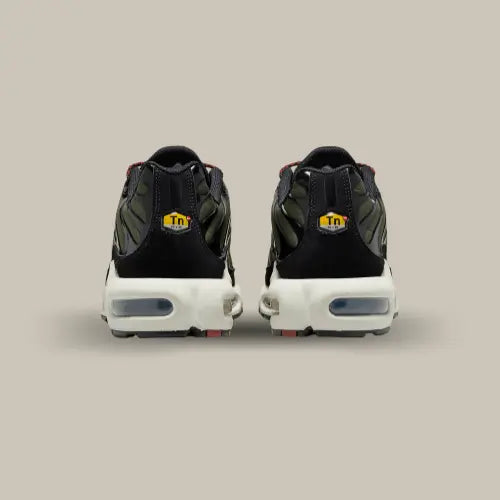 L'arrière de la Nike Air Max Plus TN Cargo Khaki Phantom avec son empiècements en TPU noir comportant le logo TN dans un petit hexagone jaune.