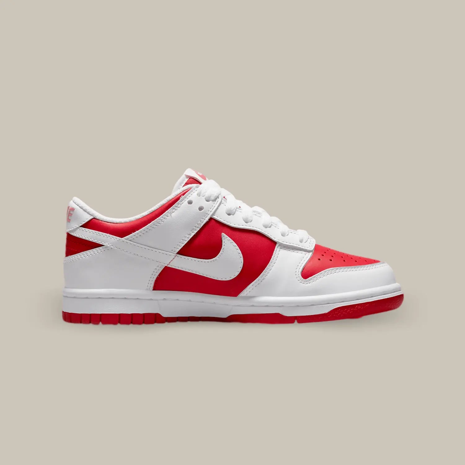 La Nike Dunk Low Championship Red de coté avec sa base en cuir rouge vif, sublimée par des superpositions en cuir blanc.