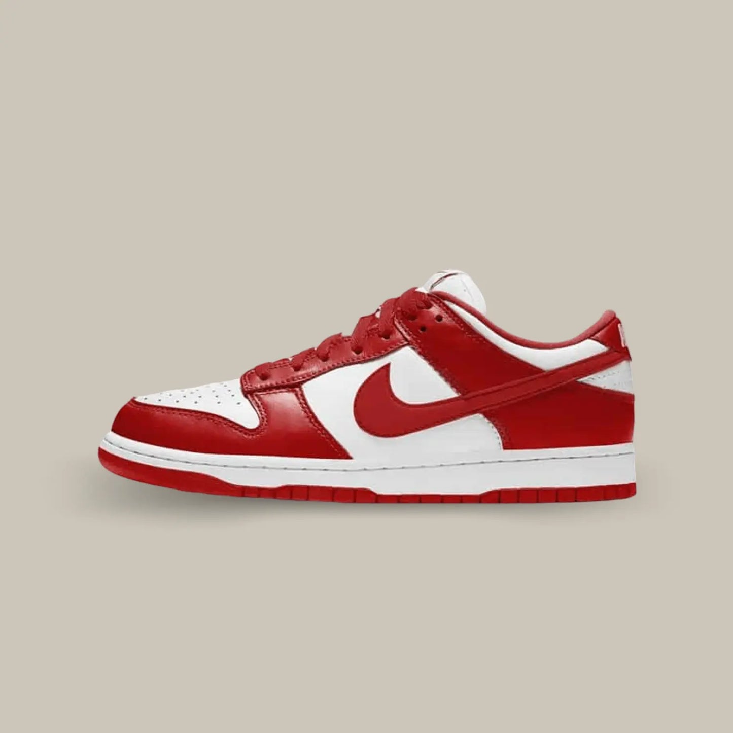 La Dunk Low University Red de coté avec une base en cuir blanc accompagné d'empiècements rouge.