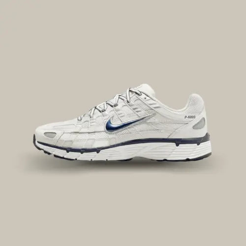 La Nike P-6000 Obsidian Summit White vue de côté avec sa base en mesh blanc et son swoosh bleu osbidien.